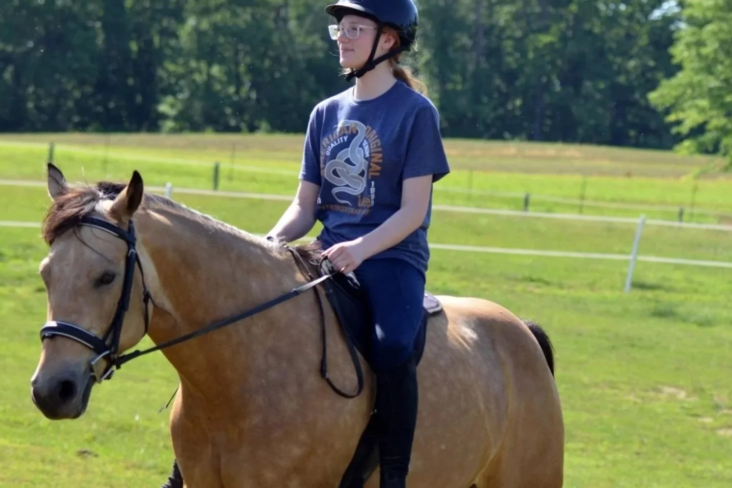 Student riding horse at King's View Acres Summer Camp