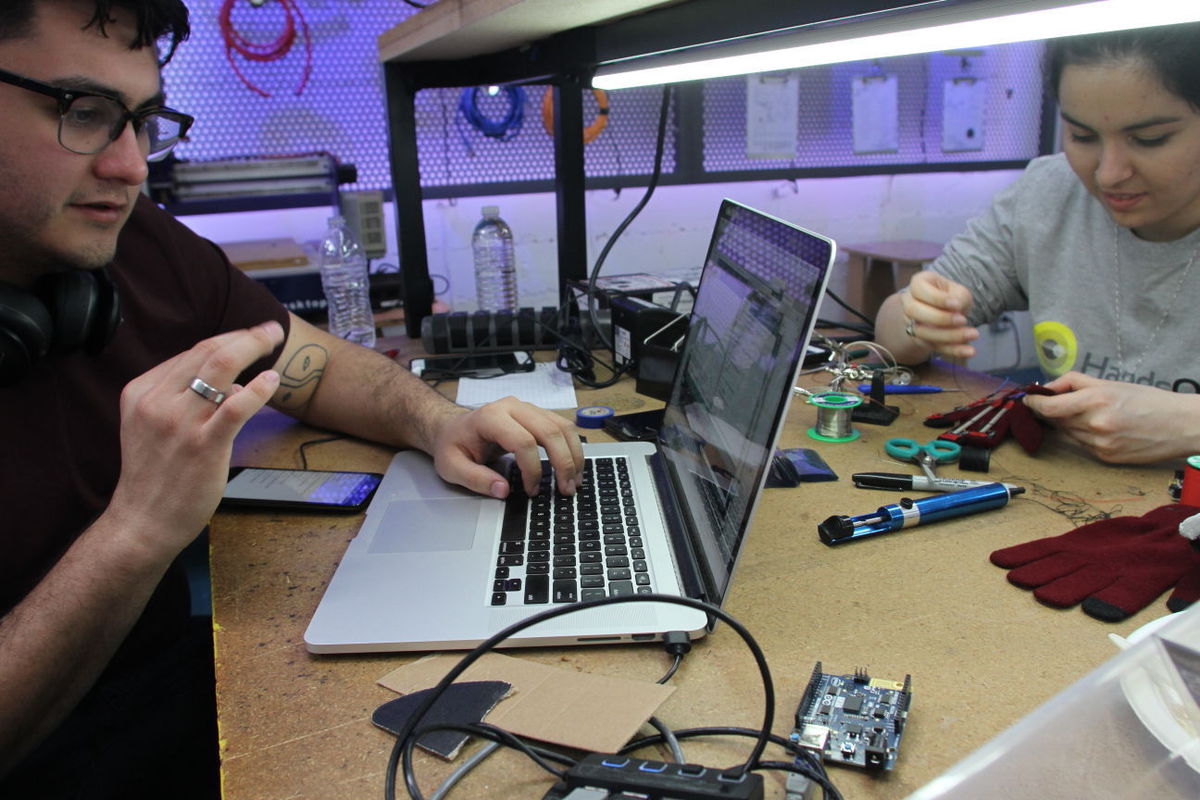 Mira Frenkel of Tucson, working at right, with teammate Brendon Villalobos, is competing for a $1-million prize on "America's Greatest Makers," a TV show about an Intel-sponsored competition to design and build new technology. They built a glove that translates the hand motions of American Sign Language into spoken words.