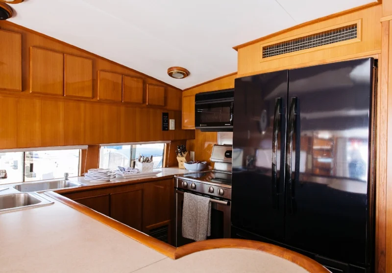 Full size galley with double refrigerator, stove, oven, microwave, and Nespresso machine