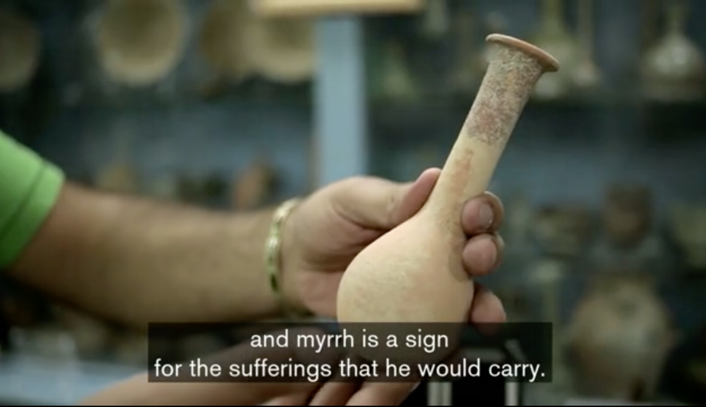 An antiquities dealer in Bethlehem shows a traditional container for myrrh, one of the three gifts the Magi brought to Jesus. (screenshot from following video)