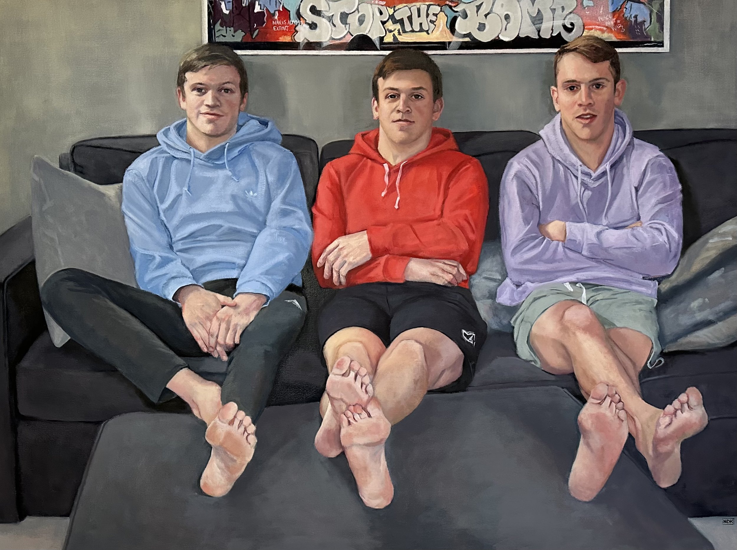 Painting of three teenage boys sitting barefoot on a black couch with a colorful graffiti-style artwork behind them, wearing hoodies and shorts.