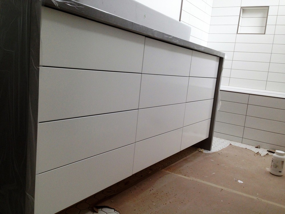 Vanity. Gloss white finish. Waterfall stone top