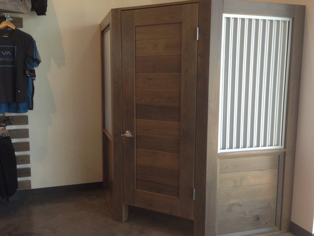 Alder retail change room with galvanized metal inserts.