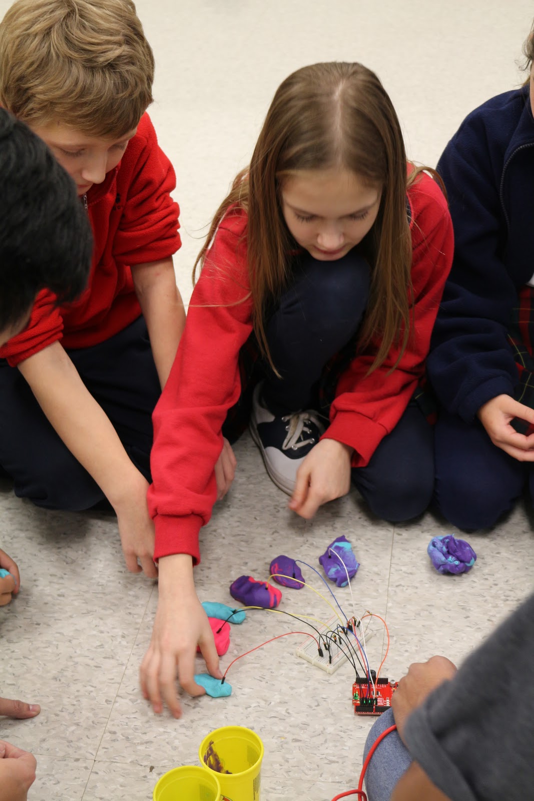 Parish students "play testing" our play-doh piano kit.