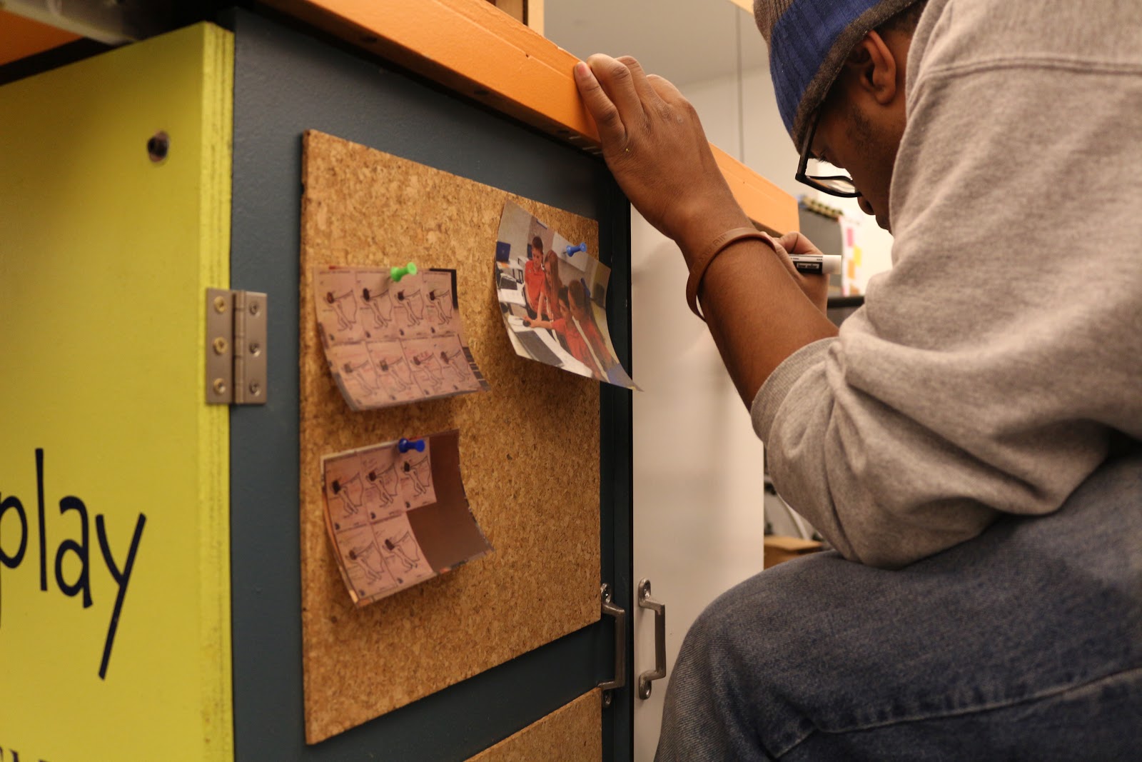 Decorating the cork boards with pictures from the past week.