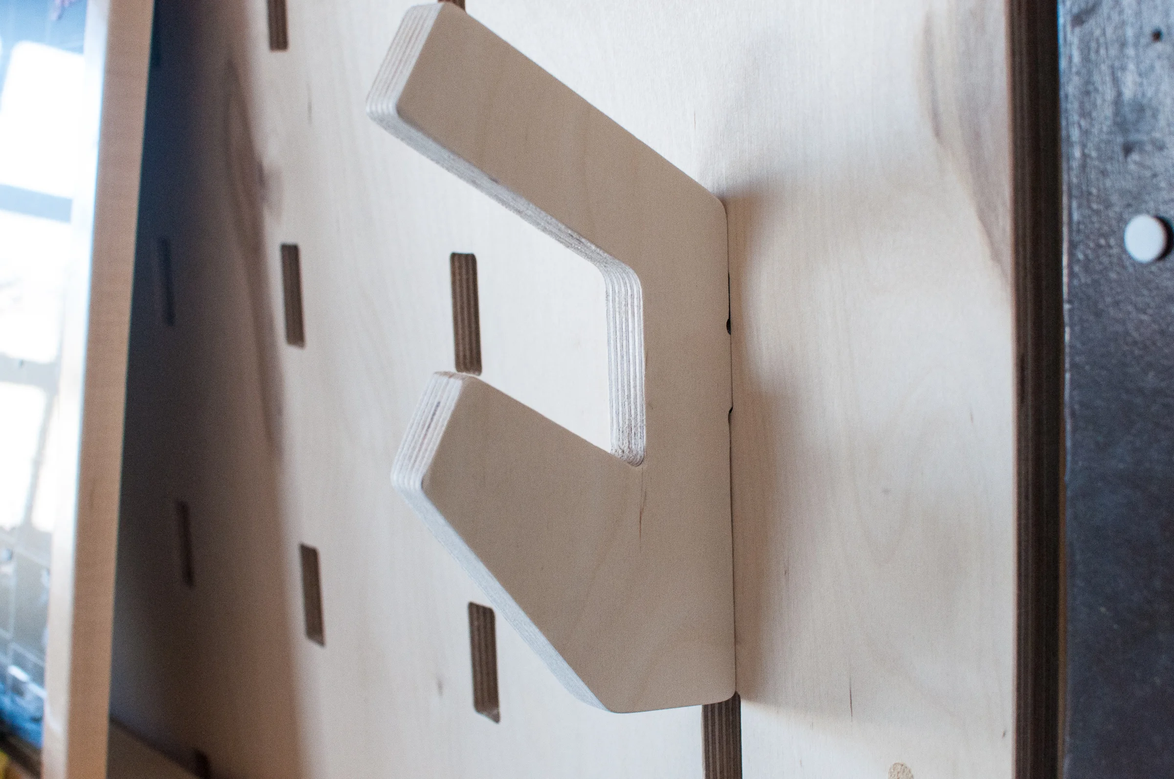 A coat hook made by Better Block slots into one of the many holes on the wall at Better Block HQ.