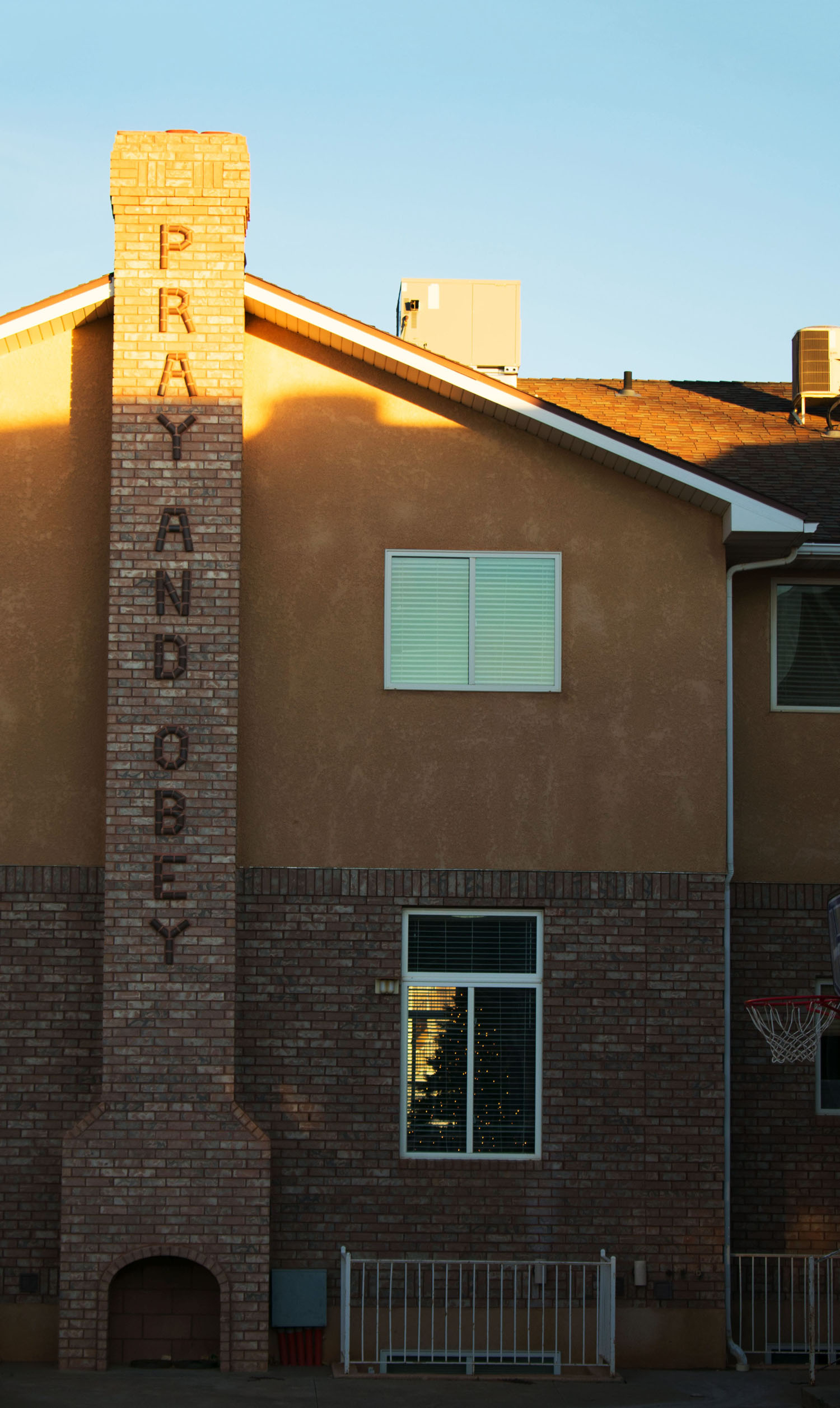 Warren Jeffs' frequent mantra on the chimney outside his old house. Dream Center's Christmas tree is visible through the window.