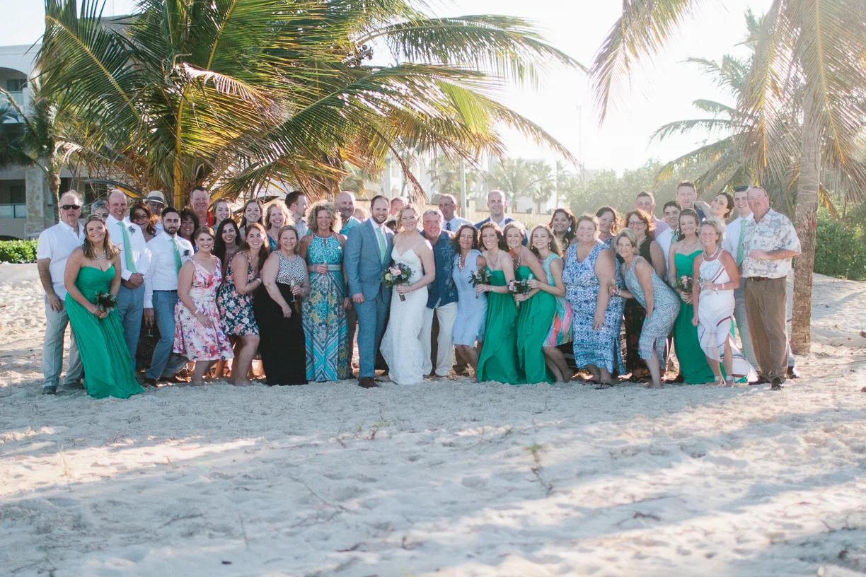 Punta Cana destination wedding, beach front wedding ceremony at sunset, wedding party and guests