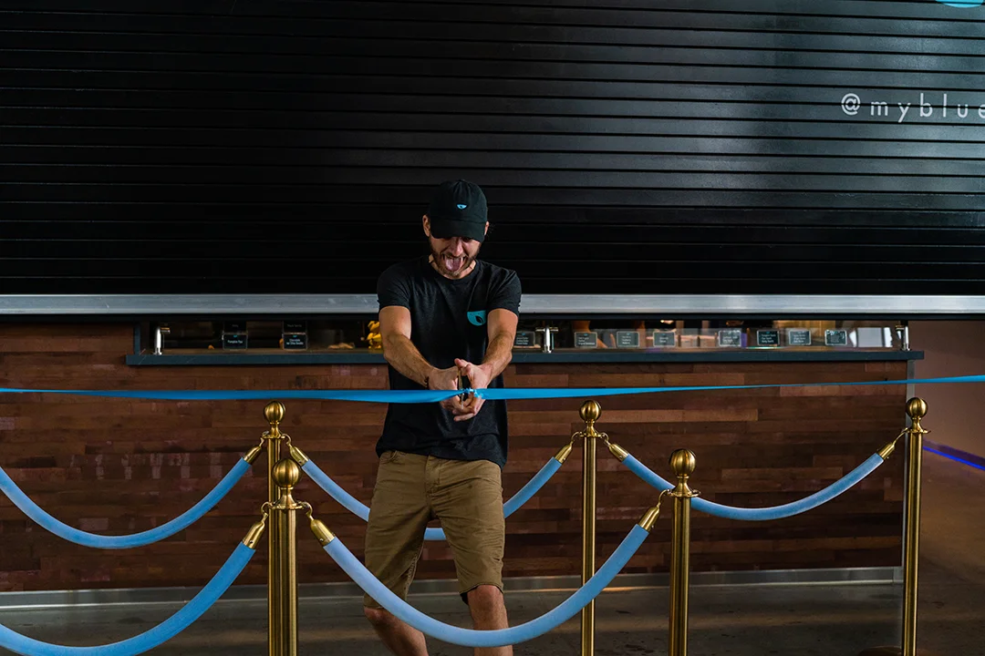 Our manager Jake cutting the ribbon!