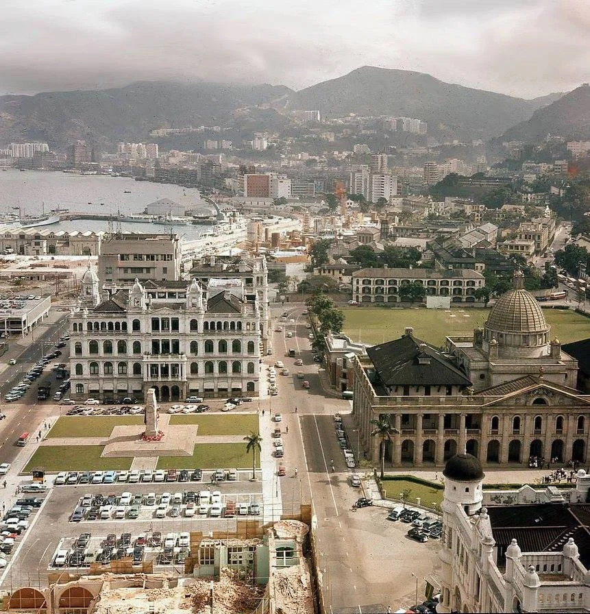 Photograph of central district showing the Supreme Court on the right, the old Hong Kong Club building and the Royal Hong Kong Cricket Club grounds!