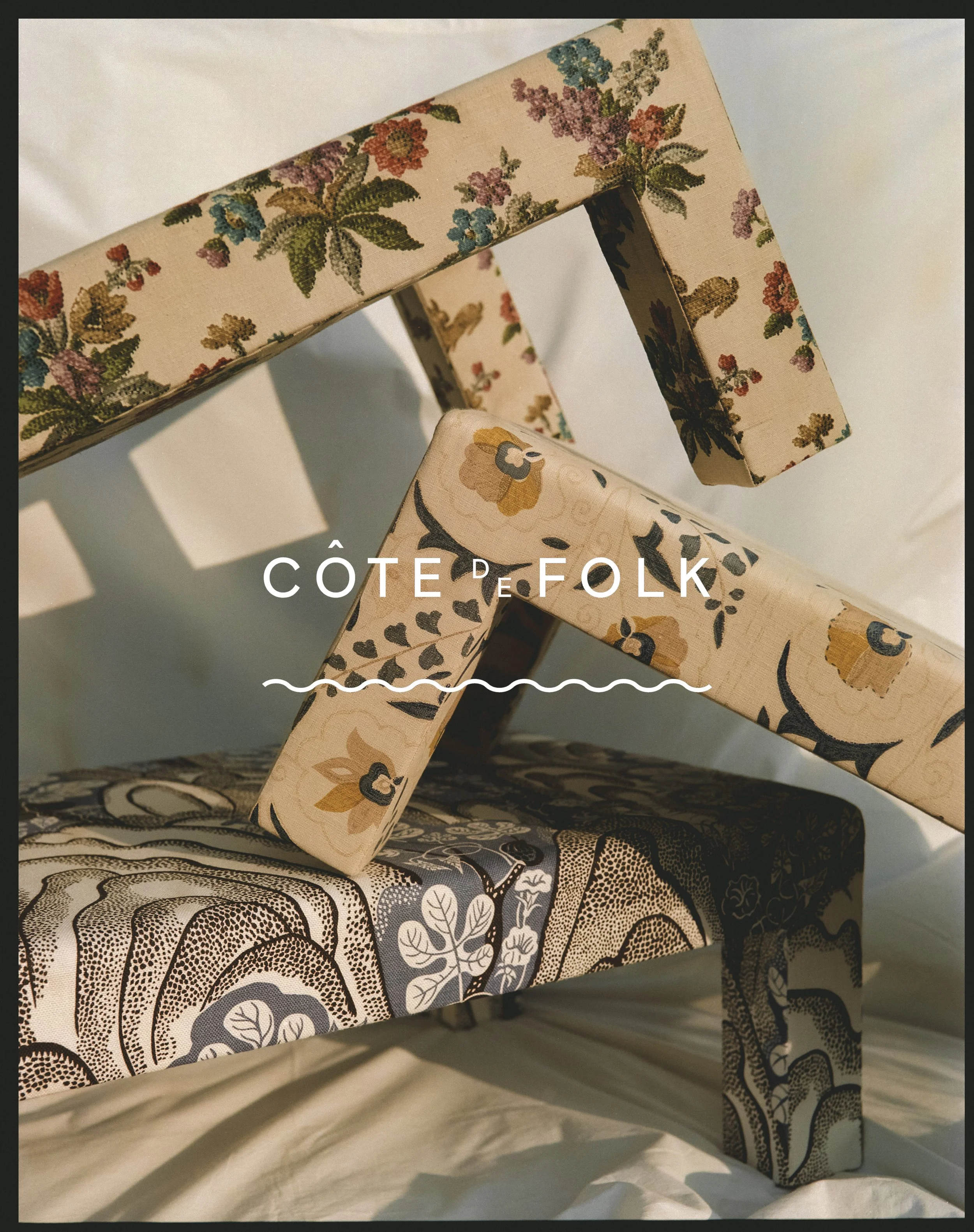 Close-up of a wooden chair with a floral patterned cushion and backrest, featuring various flowers and leaves designs in neutral and earthy tones.