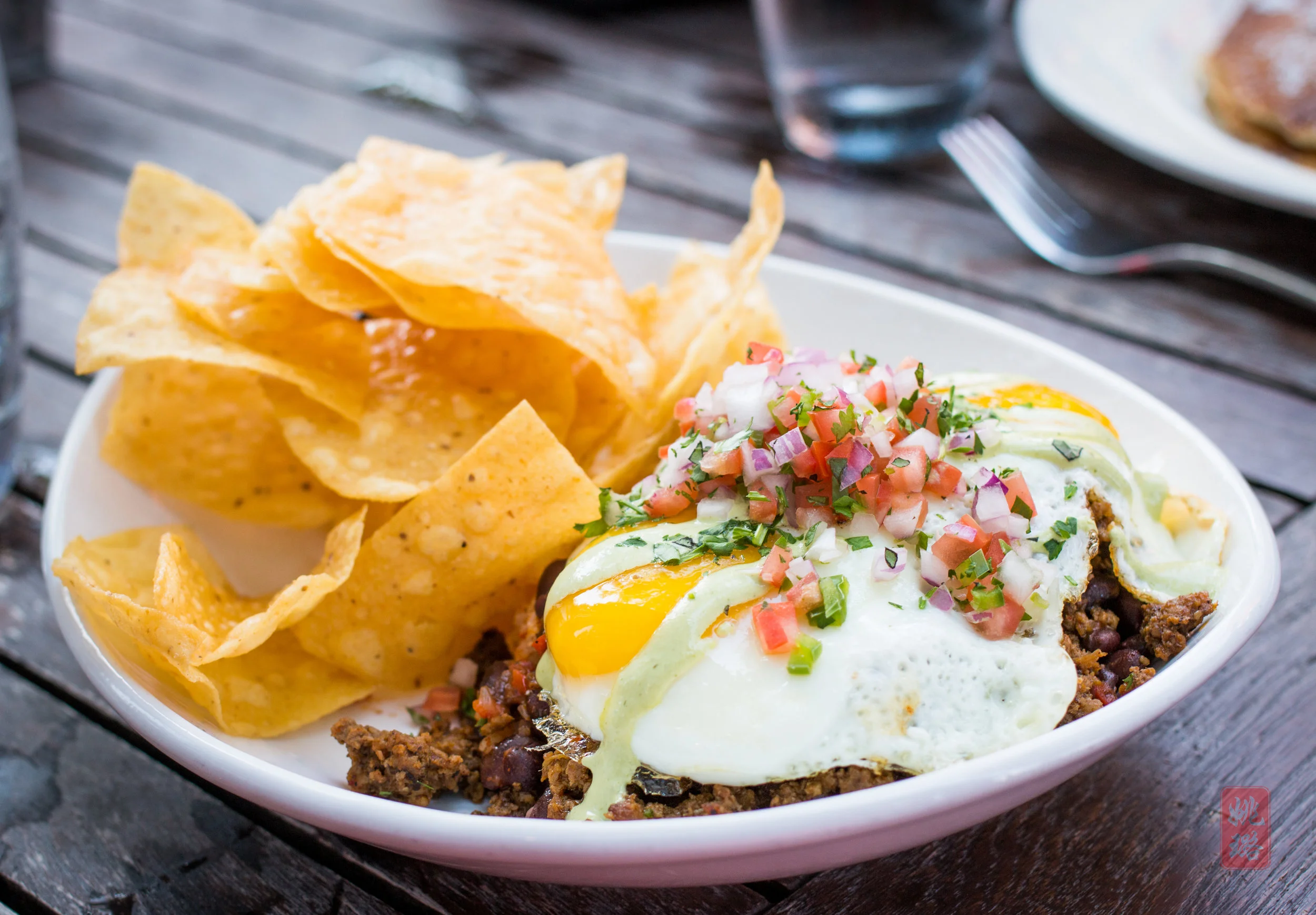 Huevos rancheros - house made chorizo, Mexican rice, Chipotle black beans, cilantro-lime crema with tortilla chips