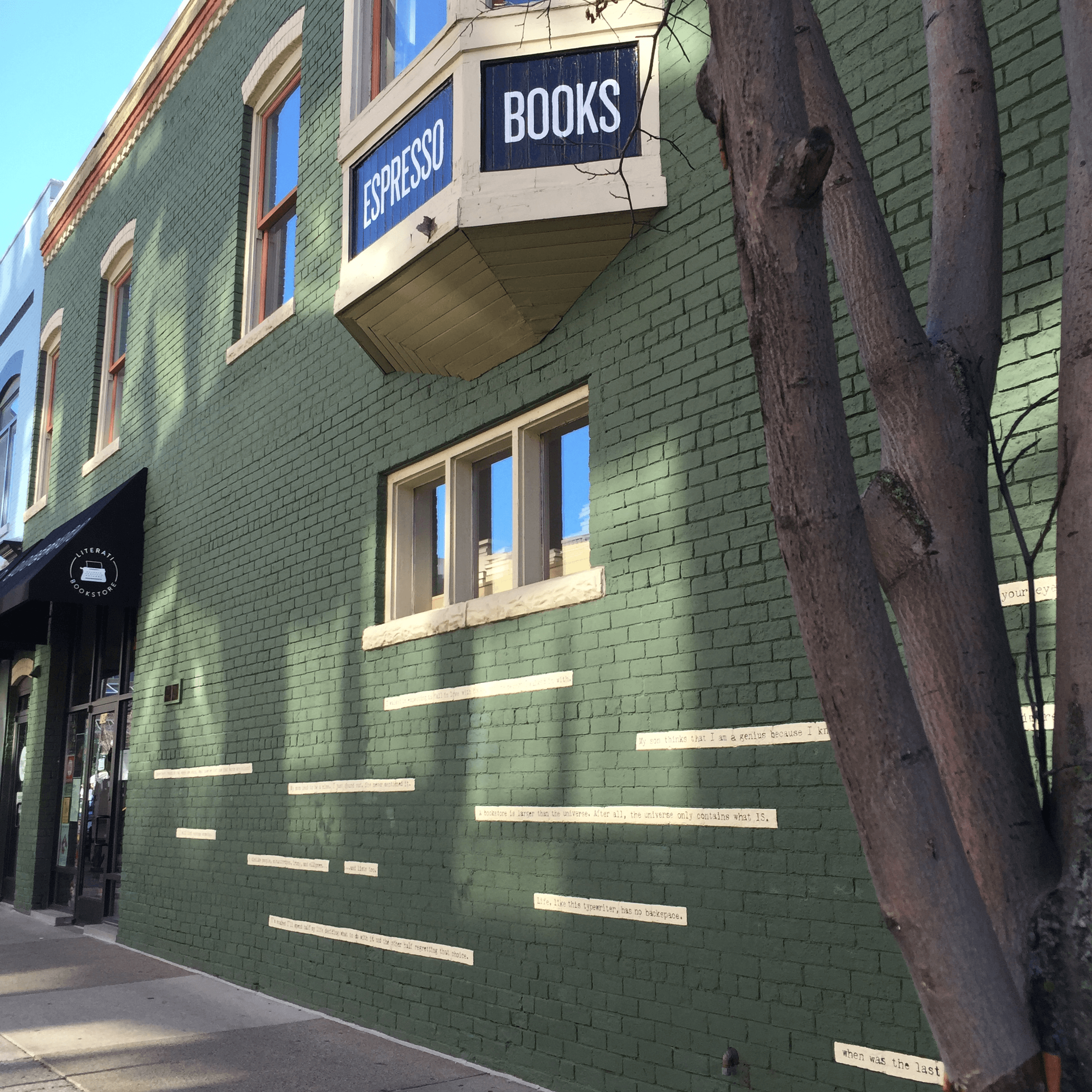 All done: branded awnings, bay window lettering, and a mural