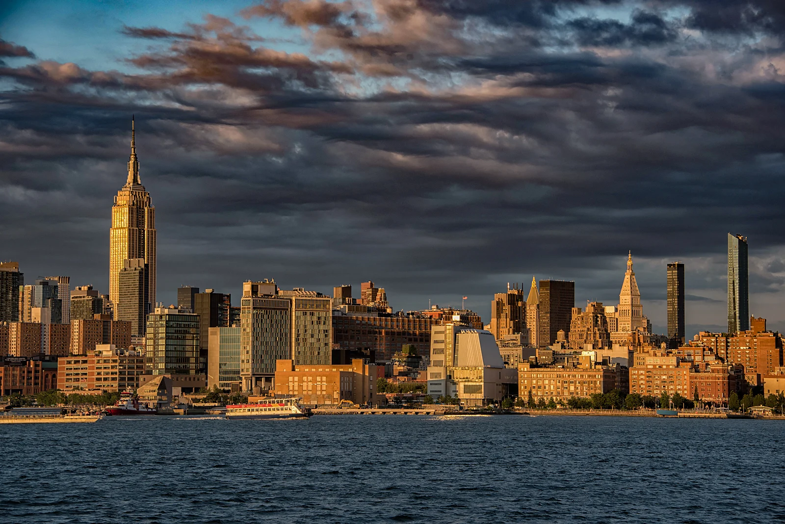 Midtown spotlighted by the sun about 20 minutes before sunset, with a clearing storm in the background. Taken from Hoboken Pier C