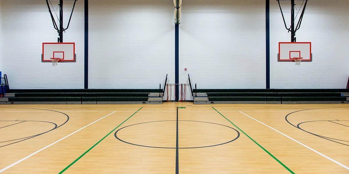 empty indoor dual basketball courts