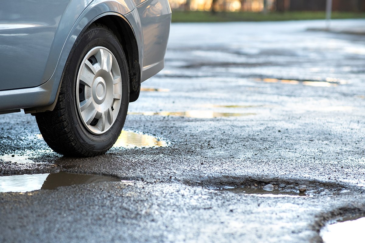 car-on-a-pothole-ridden-asphalt-street-2026-09-21-07-35-17-utc.jpg