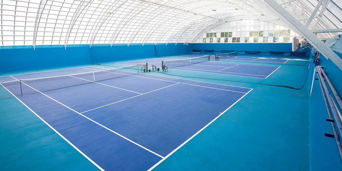 indoor tennis court with blue floor