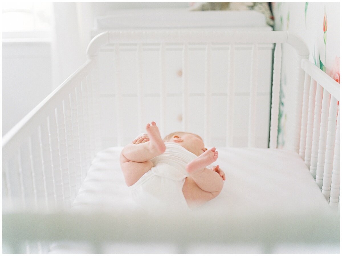 A baby in a crib during a newborn session