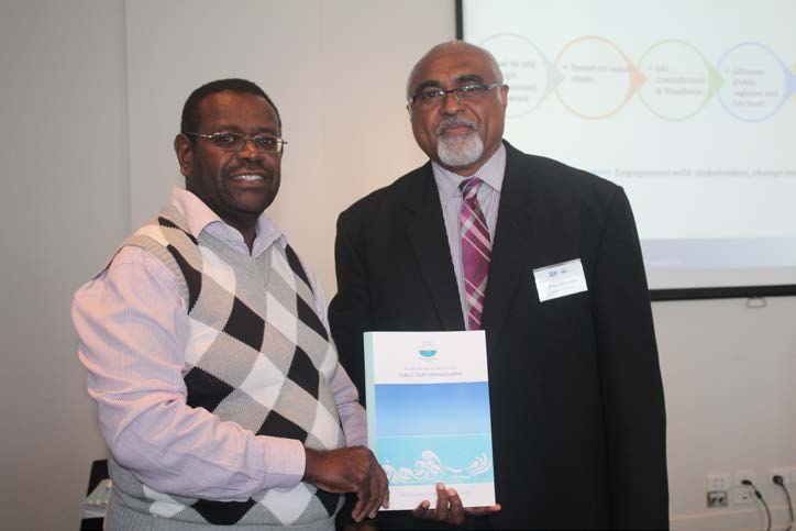Launching of Regional Report – PASAI Advocate Mr Eroni Vatuloka handing over the regional report officially on behalf of PASAI to Mr John Path Chairperson of PASAI Governing Board