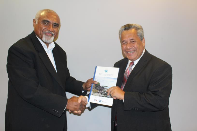 Photo: PASAI Advocate, Mr Eroni Vatuloka handing a copy of the regional report to the PASAI Chairperson, Mr Iso Ihlen Joseph at the launch. 
