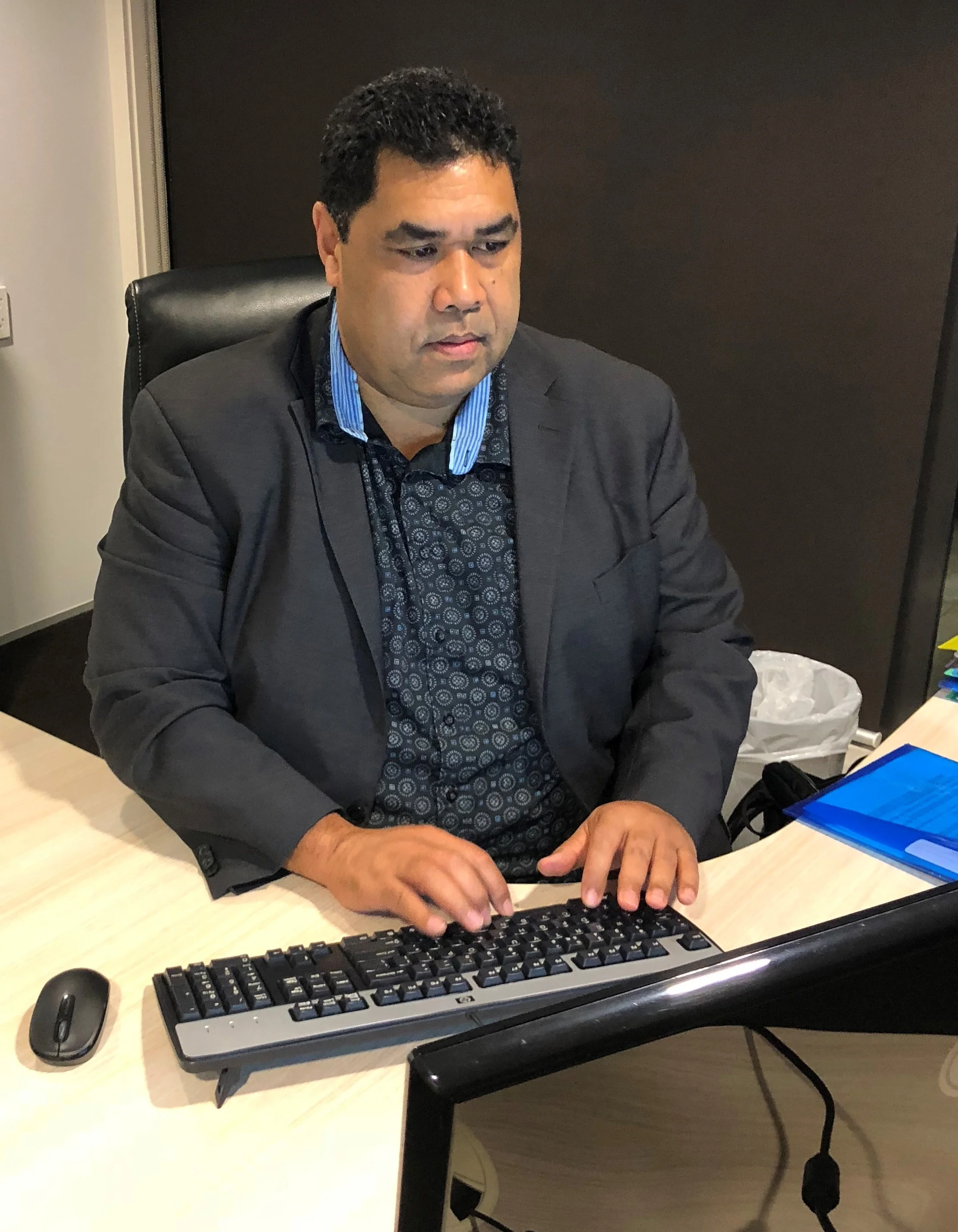 Tio at desk reporting article (2).jpg