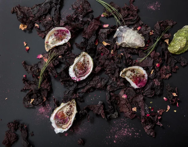 Tessa Liebman_Oysters with Dulse and Rosepetals, after MAINE by MCMC Fragrances_photographer Caroll Taveras_2018_this was a collaboration with photographer Caroll Taveras. I art directed and styled the photo which is an abstract plating of a dish that was created for a dinner with the perfumer Anne McClain of MCMC Fragrances and is based on her scent MAINE. Tessa Liebman_2018_Photo is by Caroll Taveras and art directed/styled by Tessa Liebman_the photo is a fantasy plating scheme for a dish based on a fragrance created by Anne McClain of MCMC Perfumes called MAINE. The fragrance was inspired by falling in love with her (now) husband on a beach in Maine and contains notes of beach rose, pine, briny air and beach plum which I mimicked with ingredients such as umeboshi, dulse and other sea plants, pine essential oil and rose petals.