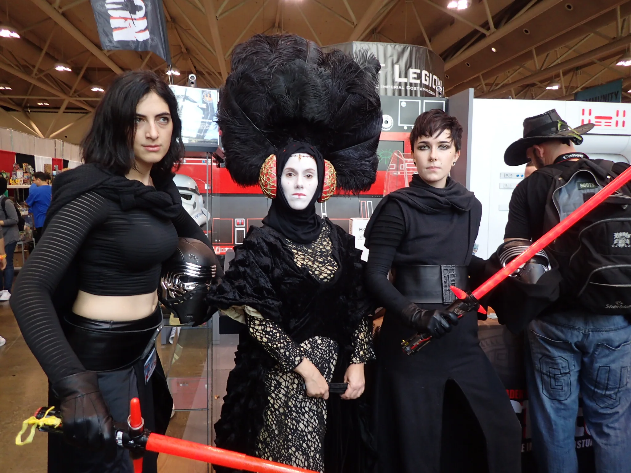 The ladies Kylo Ren pose with their grandmother. In the background you can see a guy doing what I think is a lowkey Dave Filoni cosplay. 