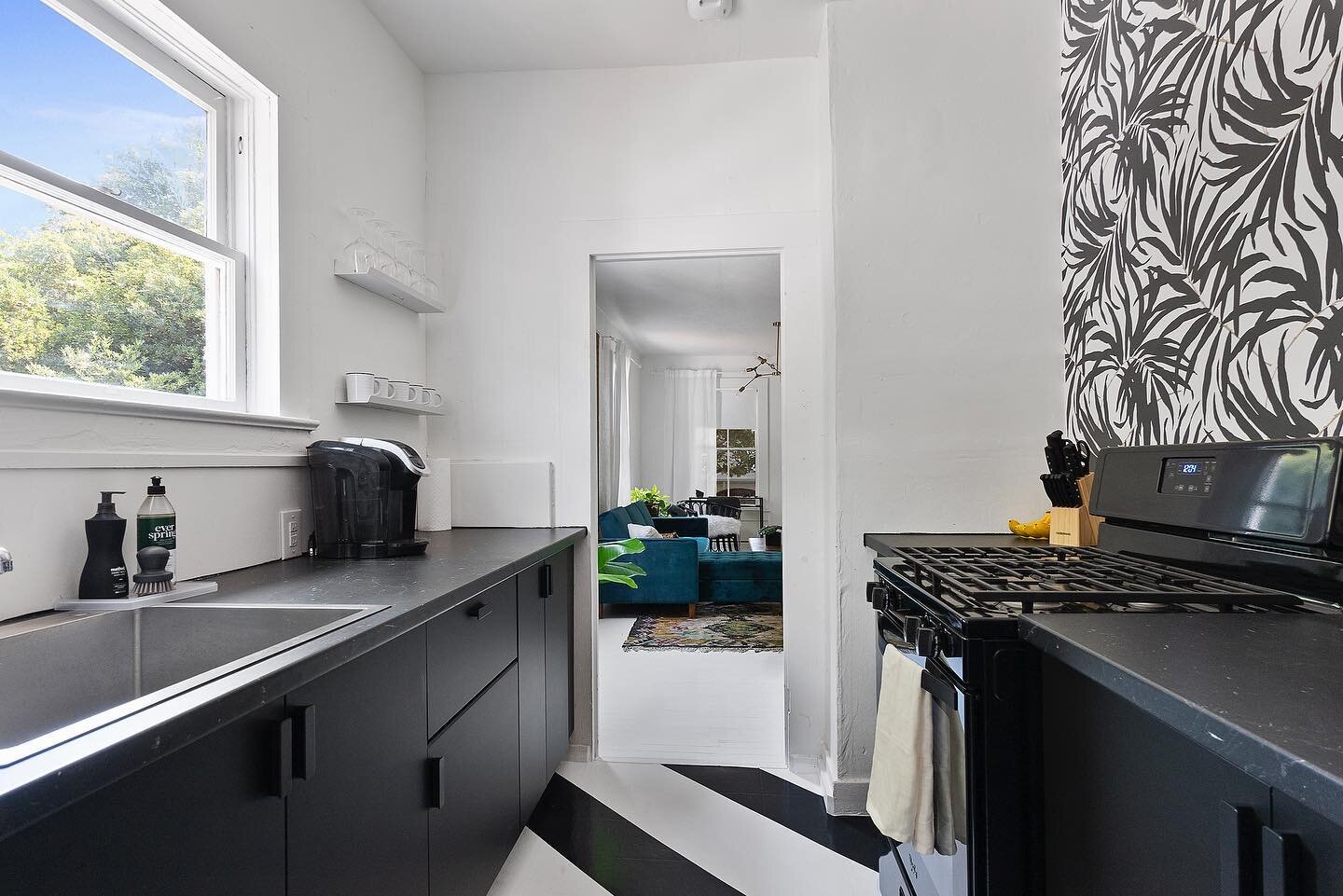 After and before! New @ikeausa cabinets and countertops, new appliances, wallpaper and painted linoleum floor. This galley kitchen got a fresh modern makeover for its 100th Bday. #airbnb #foxandfourth #airbnbmakeover #airbnbdesign #ikea #wallpaper #i