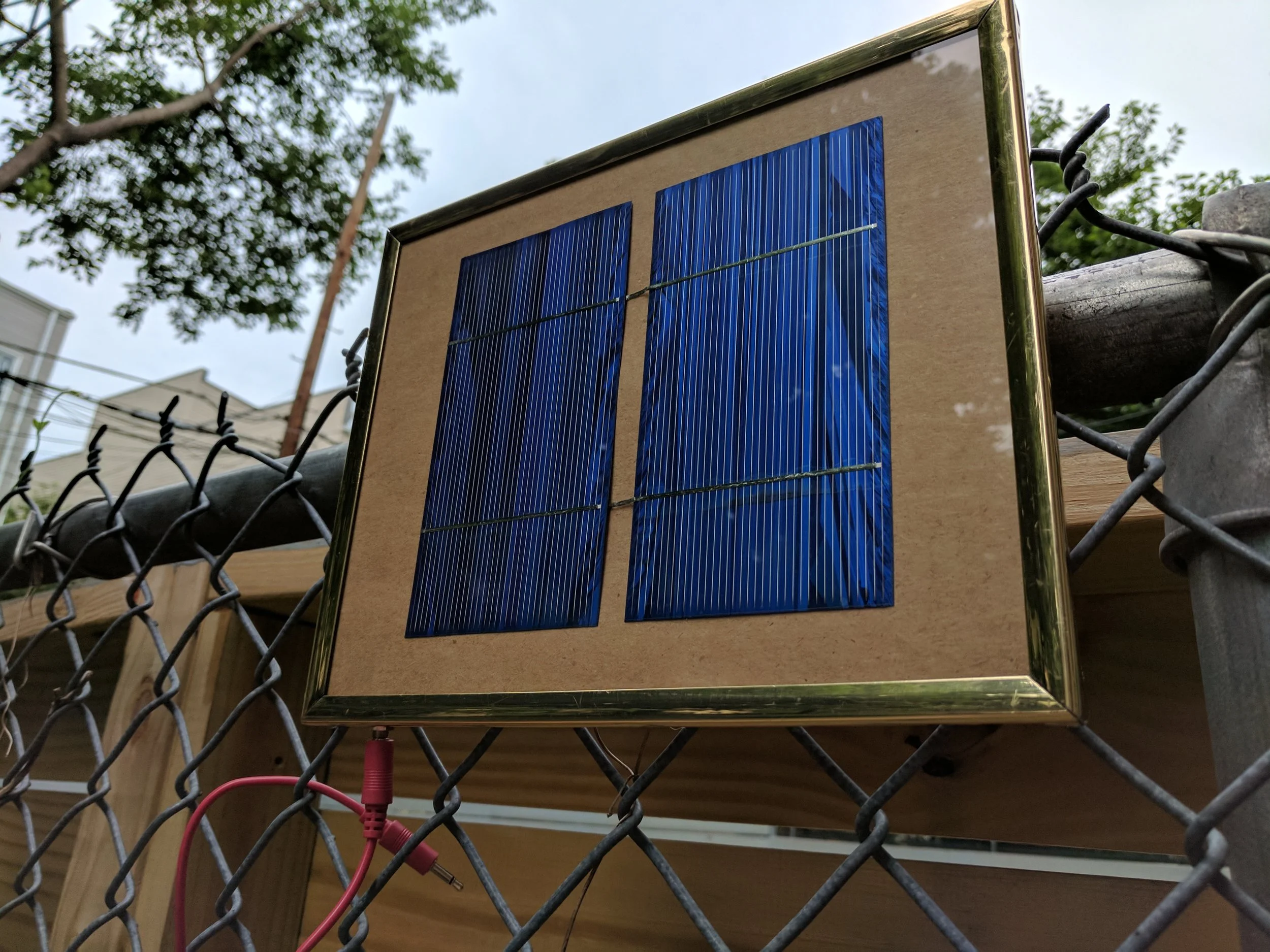 Two solar panels framed with output to a 3.5mm jack.