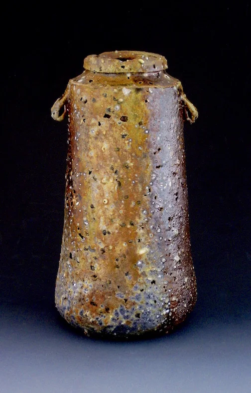 14 - vase with cornholes. 2012. wood fired unglazed clay, corn, feldspar. 10x4x4 (1).jpg