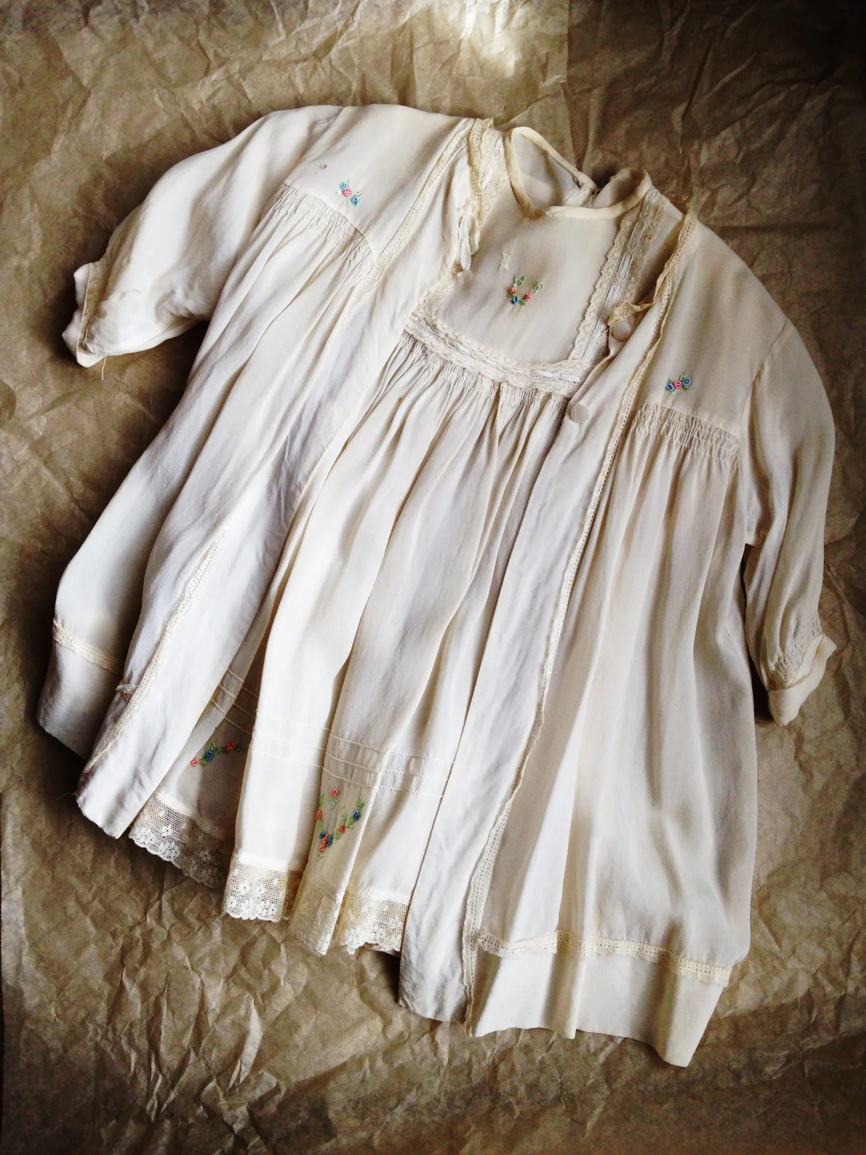 My christening 'gown' (as they were known then) - aged silk, hand smocking & rosebud trimmed. Definitely 'vintage'.