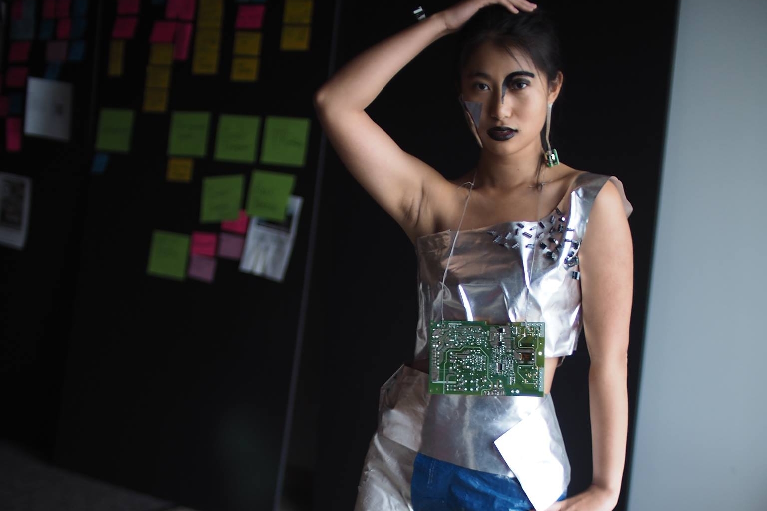 My friend models the PC, created from recycled packaging and computer scraps during an overnight hackathon.