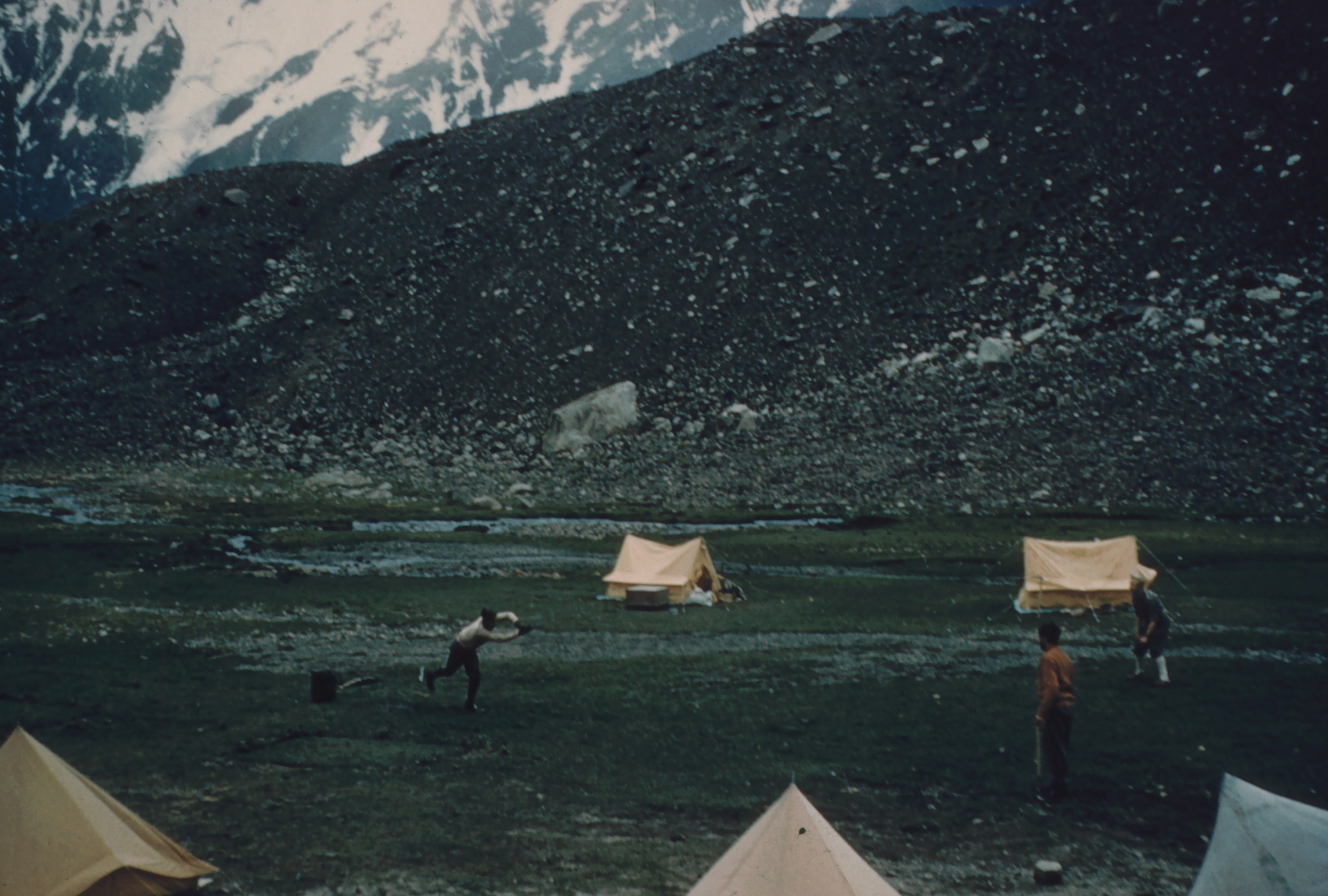 Cricket at base camp with colleagues & porters. Ted is the batsman (photo from Ted Norrish collection)