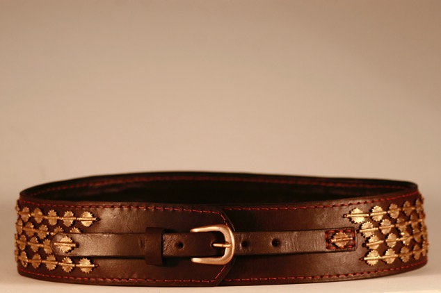 Curved belt, three lines of brass West African medallions. Variable sizes.