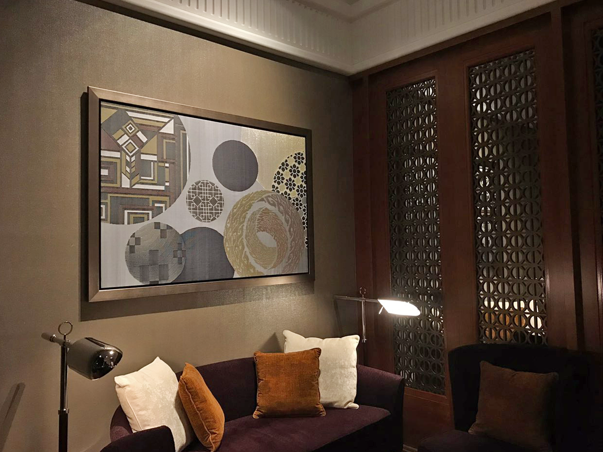 Completed songket artwork hung at the lobby lounge, mirroring the art deco design of the hotel and the multicultural spirit of Singapore.