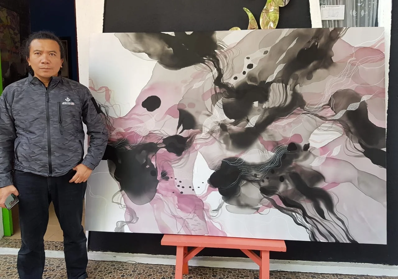 Indonesian artist John Martono with Untitled, 2018, Paint on Silk with Hand Stitching, commissioned for The Capitol Kempinski Hotel, Singapore.