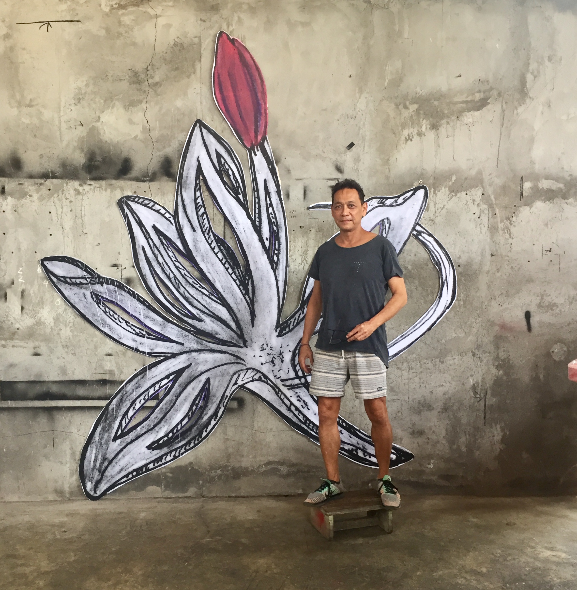 Indonesian Sculptor with Drawing of a Planned Sculpture