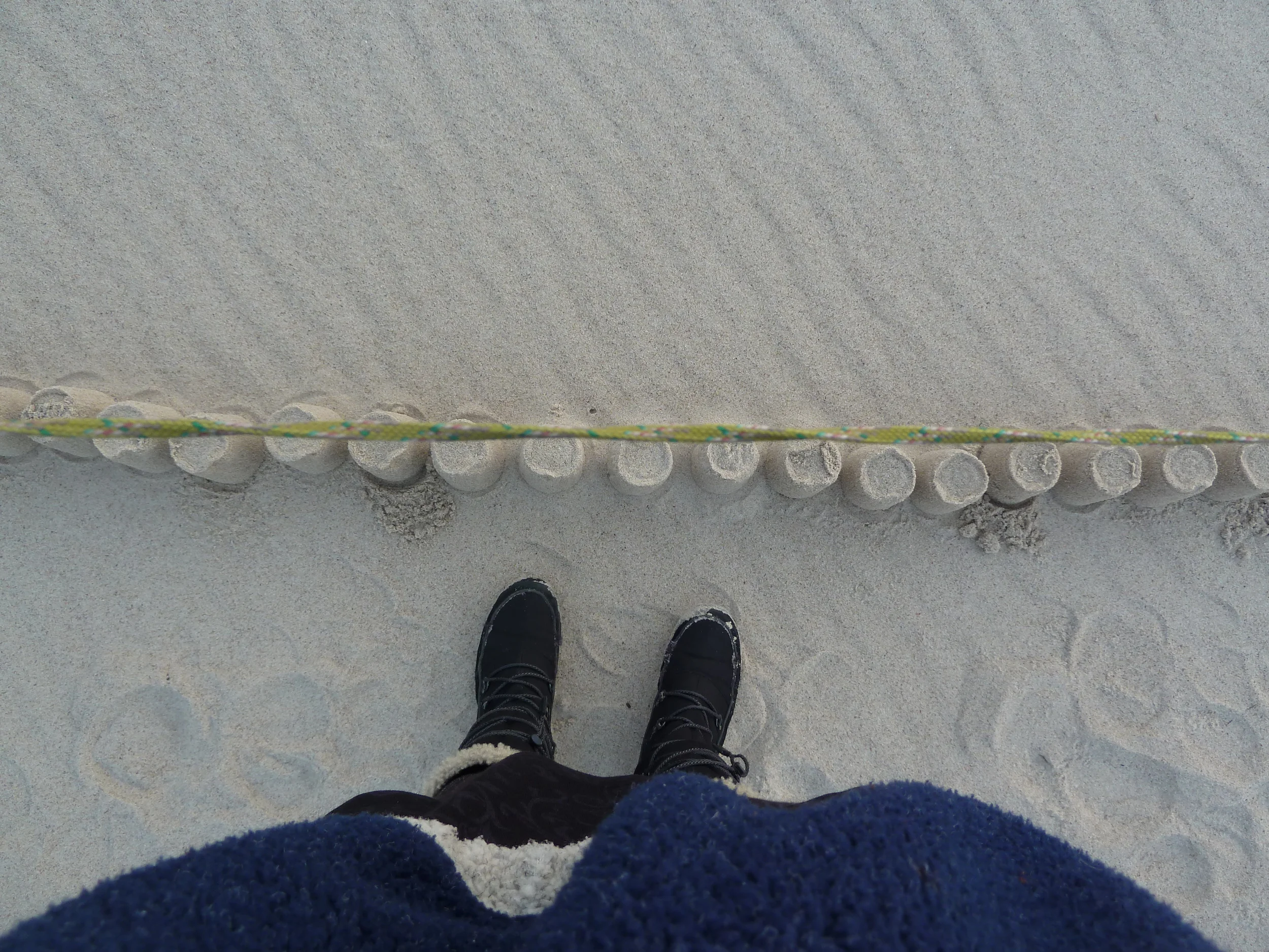     A line of sandcastles built along the border between Russia and Lithuania.  The construction of the castles lasted three hours.  The border patrol police came and observed the action for a period of time.  Our encounter went undocumented. 