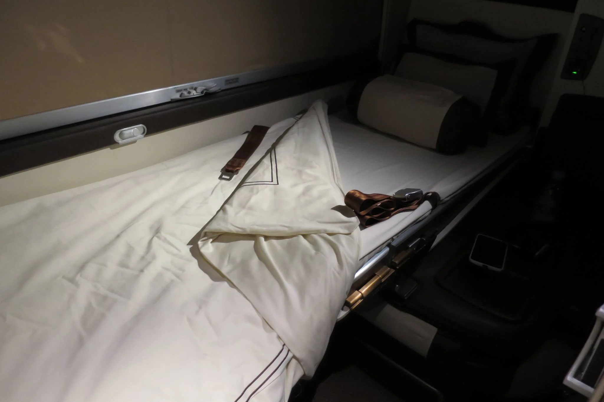 I am perfectly content with my single bed. The flight attendant made the bed in the unoccupied seat across the aisle from me so I can come and go as I please