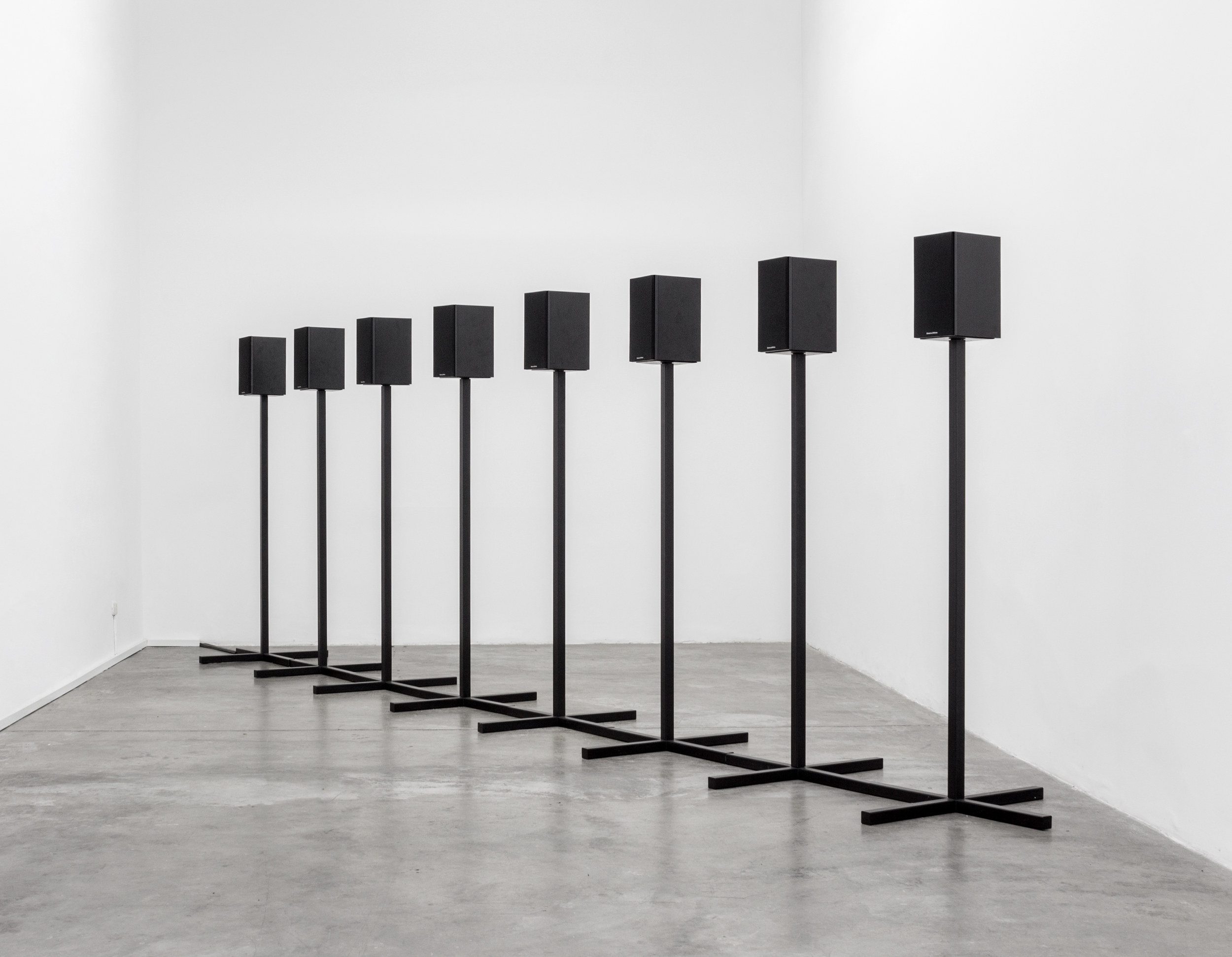   Andrea Galvani   ©   2012/2016  ,   A Cube, a Sphere, and a Pyramid #1  . &nbsp;Ultrasonic audio track (1 hour 20 minute loop), 8 loudspeakers, two-part custom black metal speaker stands, and amplifier. Installation view at Revolver Galeria, Lima. 