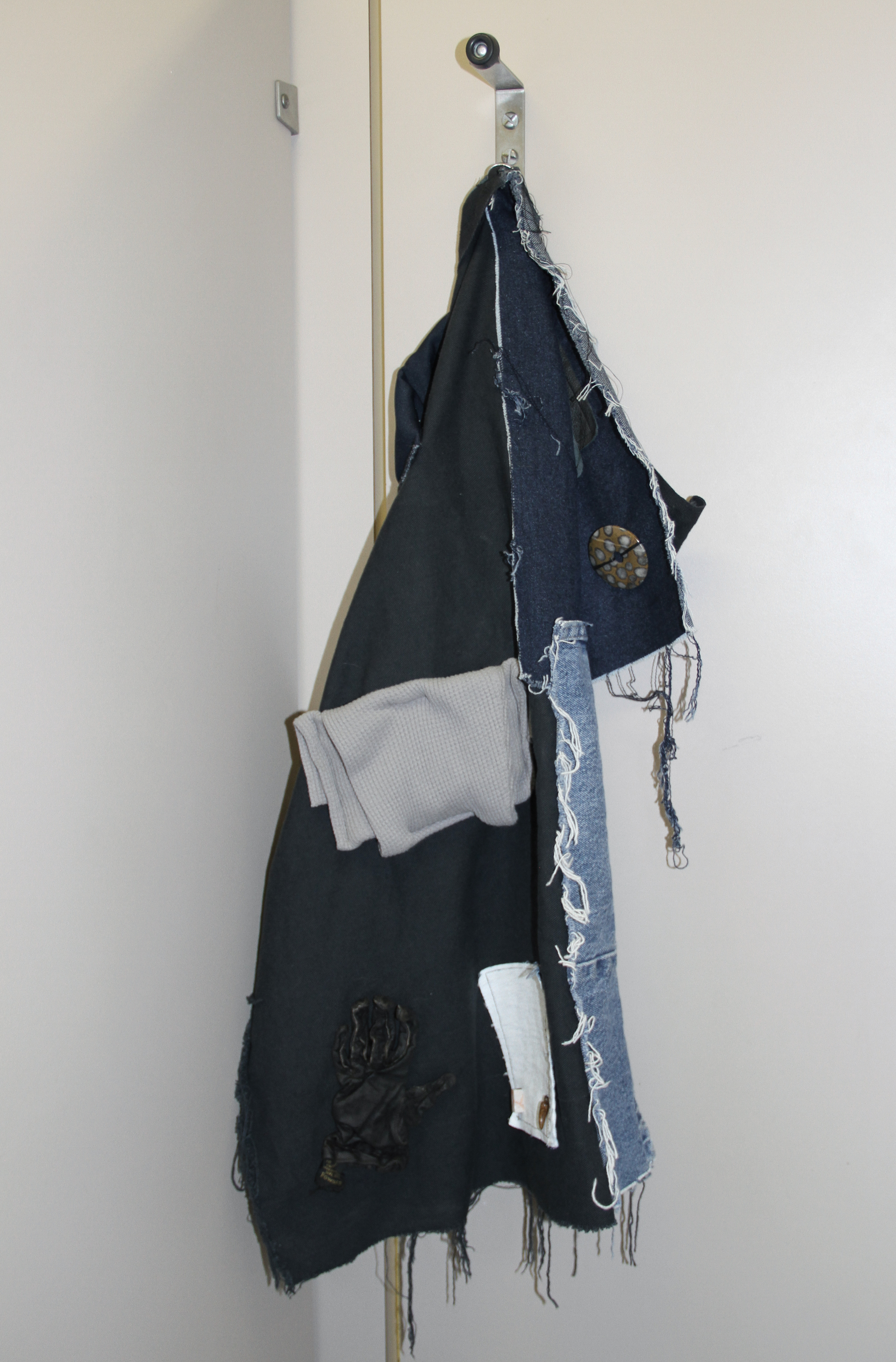   Catherine Czacki © 2016 ,  Not a Master, part III . Denim, leather, beads, stone, plastic, paint. 34 x 17 x 17 in. *Accompanied by text: Open. Courtesy of the artist. 