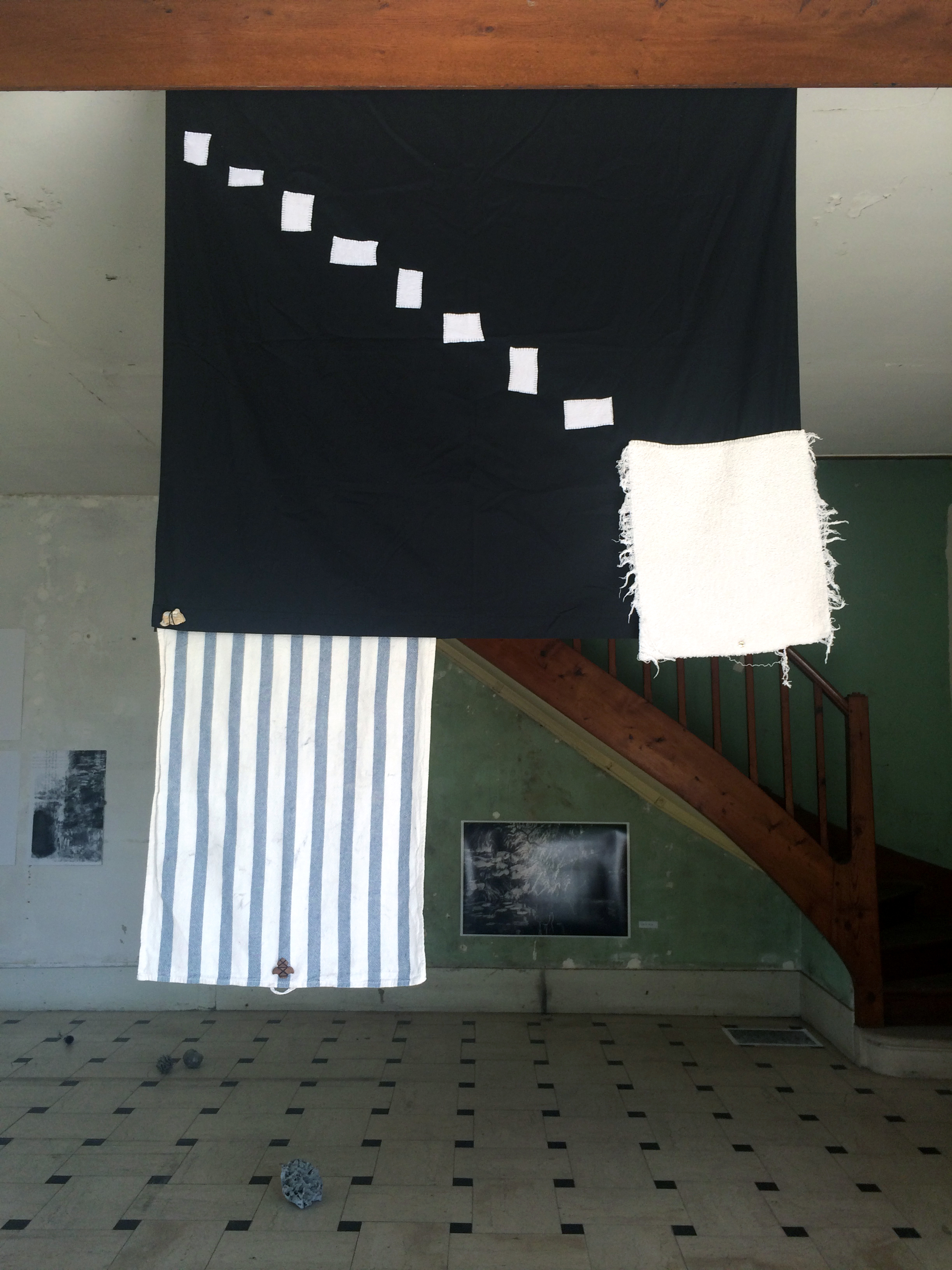   Catherine Czacki © 2015 ,  Start with death and work backwards  (Installation).  Low Plane Flag . Fabric, stone, metal, shredded towel, leaf. Dimensions variable. *Accompanied by text: Start with death and work backwards. Courtesy of the artist. 