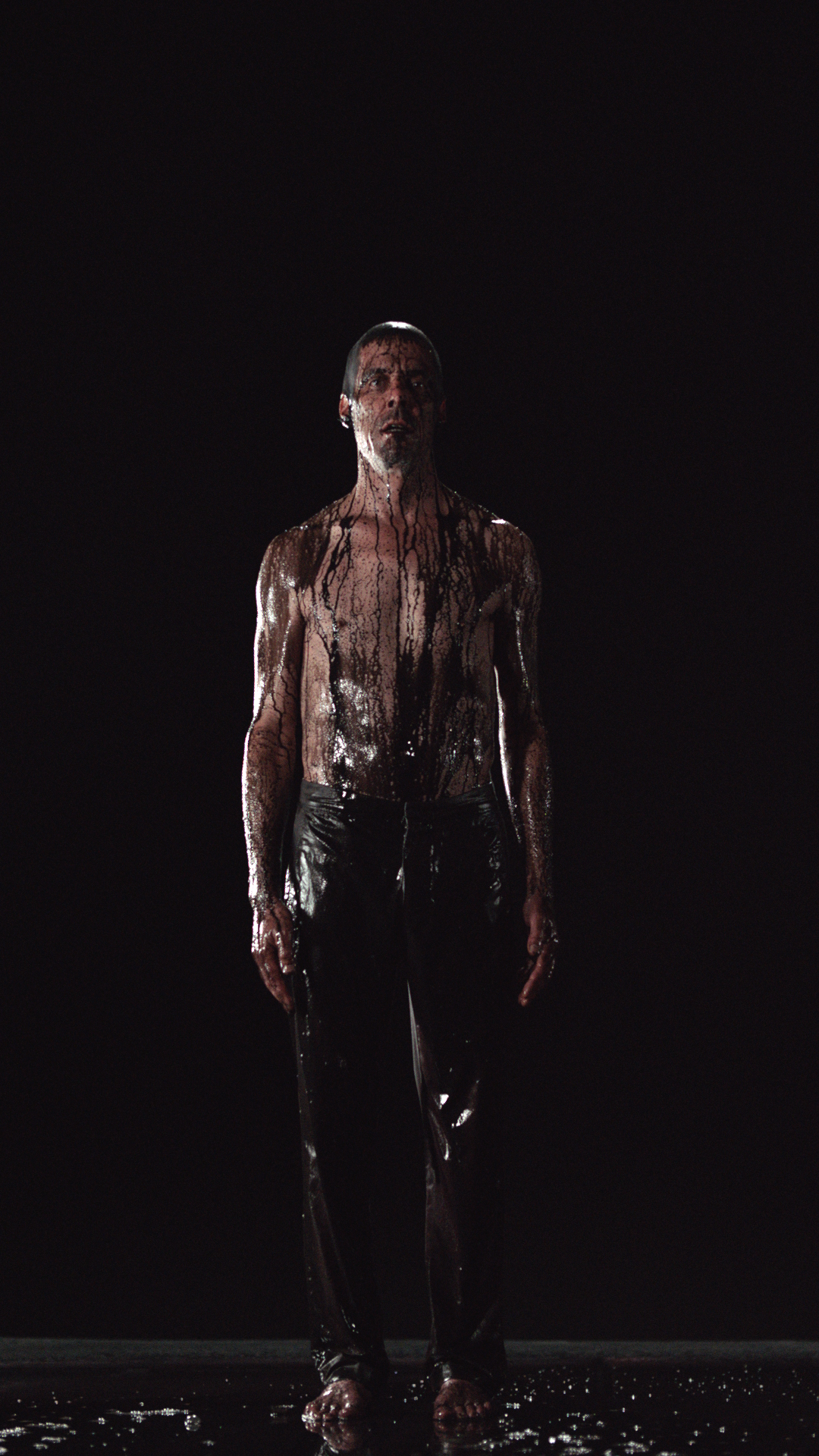 Image Above: ©Bill Viola. Inverted Birth, 2014, Video/sound installation, Color high-definition video projection on screen mounted vertically and anchored to floor in dark room; stereo sound with subwoofer (2.1), Projected image size: 16 ft 5 in. x 9 ft 3 in. (5 x 2.81 m), 8:22 minutes, Executive producer: Kira Perov, Performer: Norman Scott.