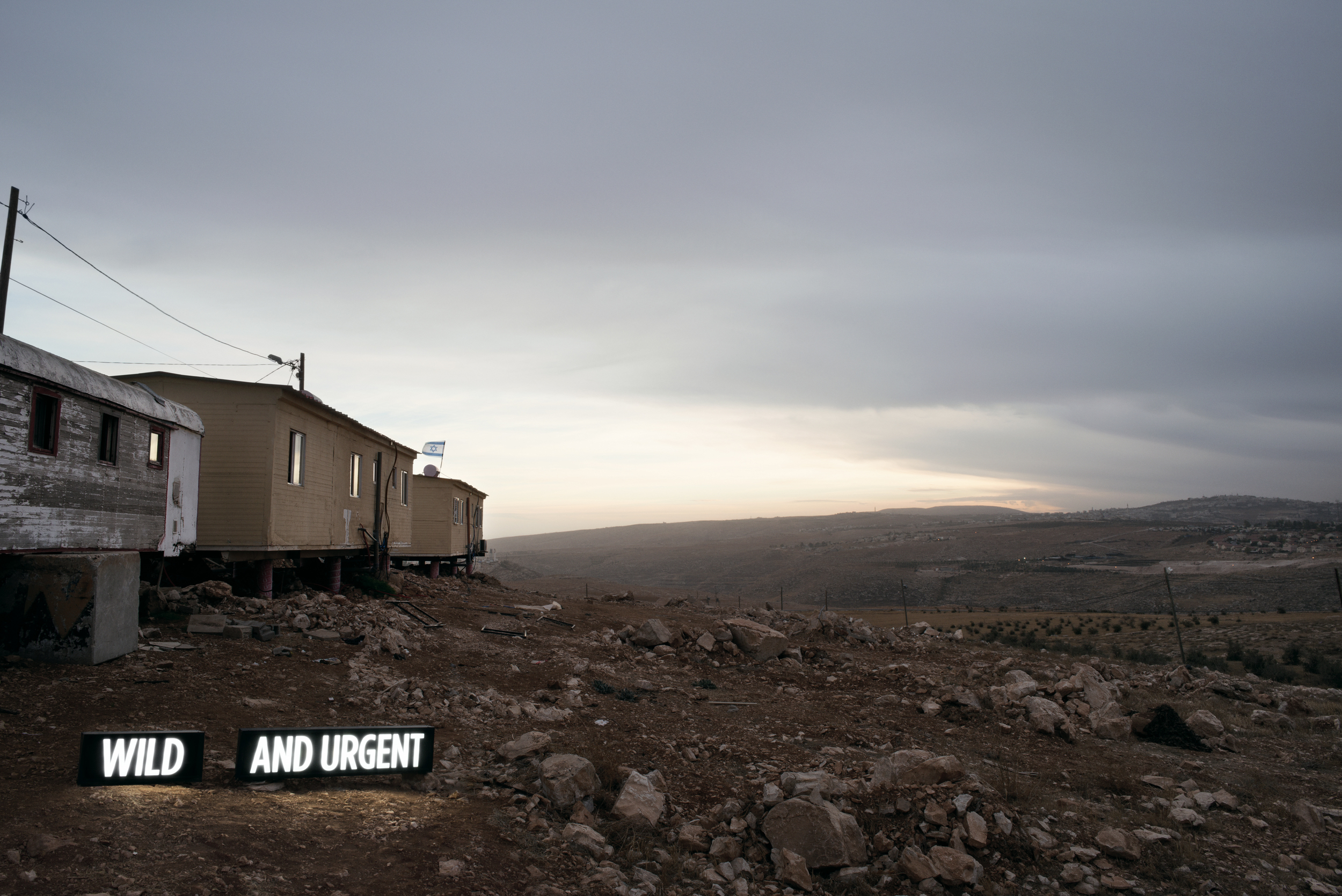 Image above: ©Shimon Attie, WILD AND URGENT (i), Two on-location light boxes, Settler Houses, Israeli Settlement, West Bank, 2014, digital c-print / Courtesy of the artist and Jack Shainman Gallery, New York.