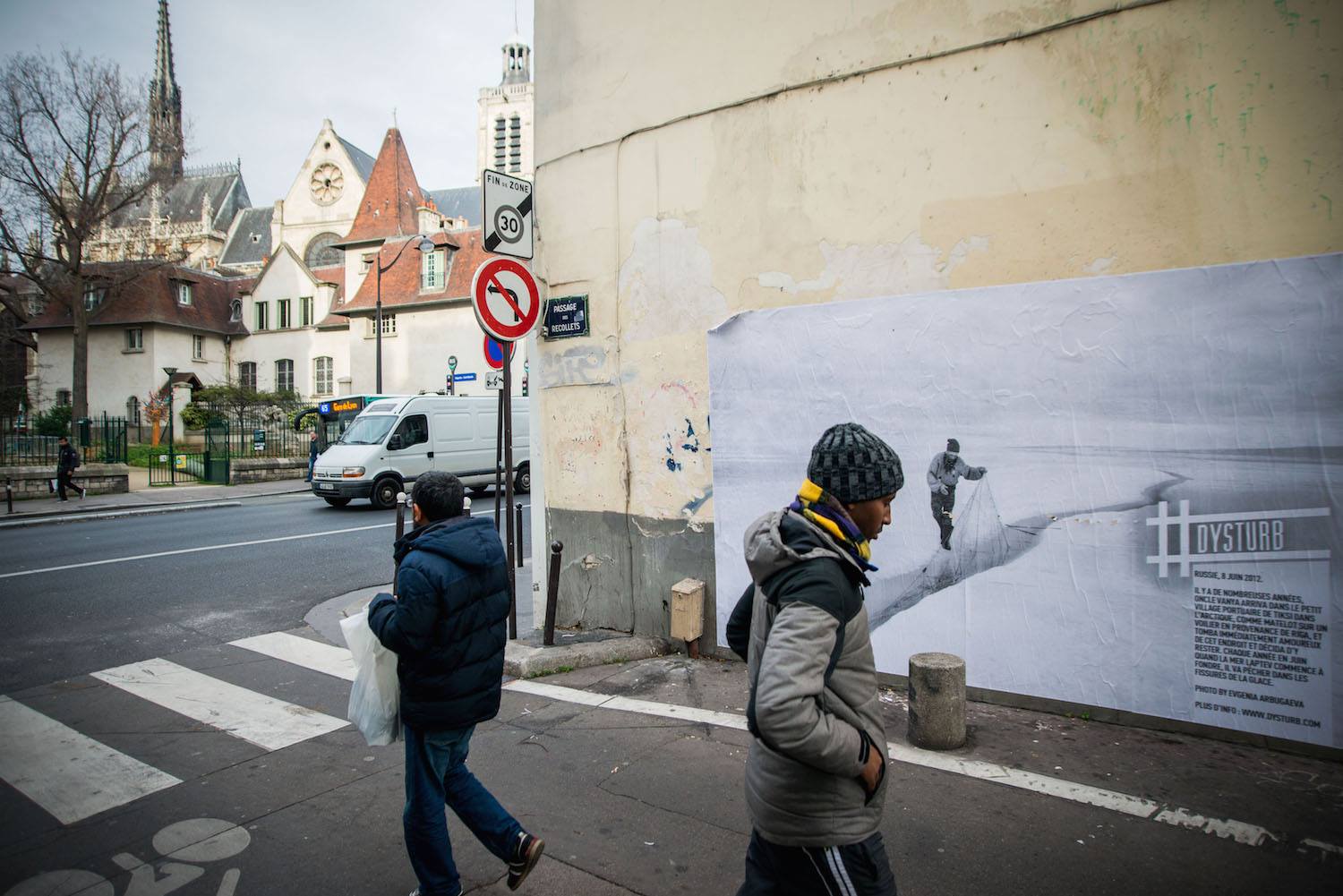 © Benjamin Girette. For COP21, we teamed up with the Magnum Foundation, Yale School of Forestry and Environ-mental Studies, NYU-ITP Students & Twillio to #reframeclimate by pasting current photojournalism in the streets of Paris. Pictured is ©Evgenia Arbugaeva's photograph which can be found on 3-5 Passage des Récollets. The caption reads: Russia, June 8th, 2012. Many years ago uncle Vanya arrived to a small Arc-tic port town Tiksi from Riga as a sailor on a ship and immediately fell in love with the place and stayed. Now every June when Laptev Sea starts to melt, he catches the moment to fish in the cracks of the ice.