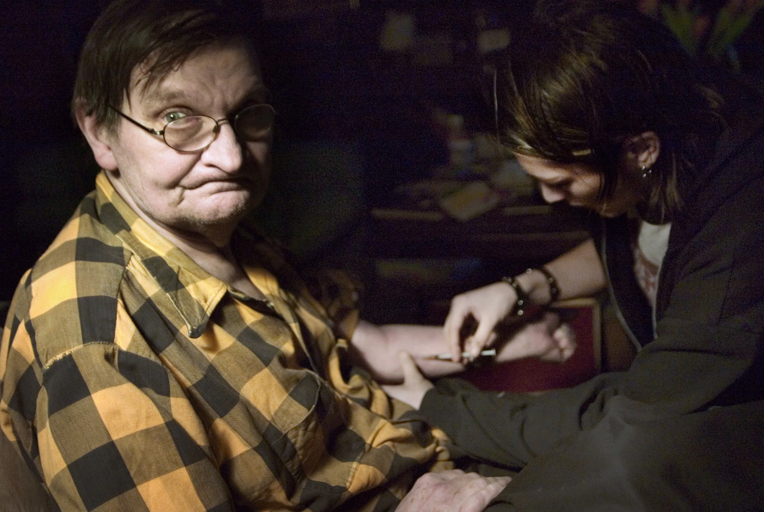 Jesse injects Old Man Joe inside his apartment in New York, N.Y. in May 2005. Joe cannot shoot himself up, and therefore is dependent on the residents to both inject him and supply him with drugs.