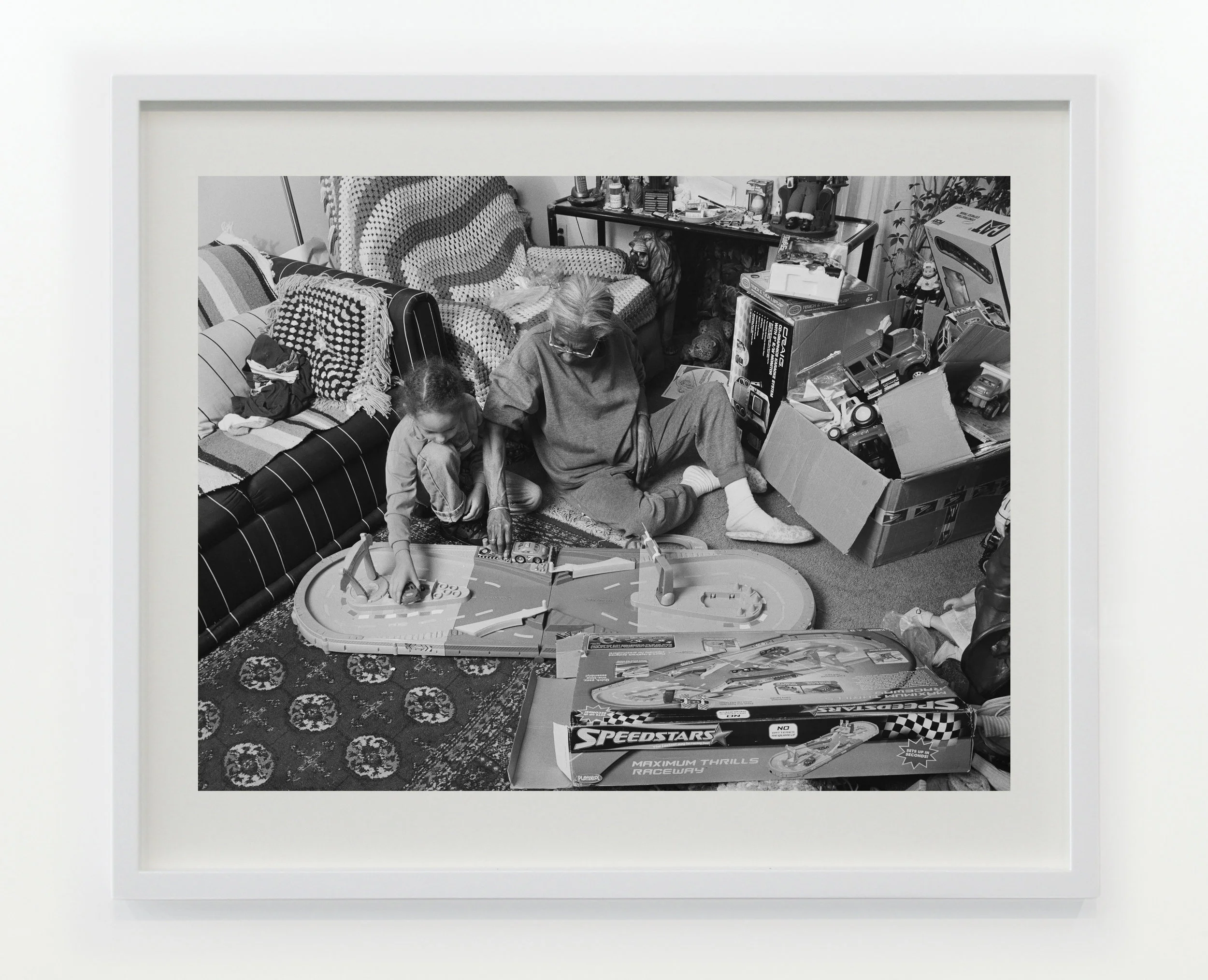 Grandma Ruby and J.C. Playing with Christmas Toys in Her Living Room, 2006 © Latoya Ruby Frazier