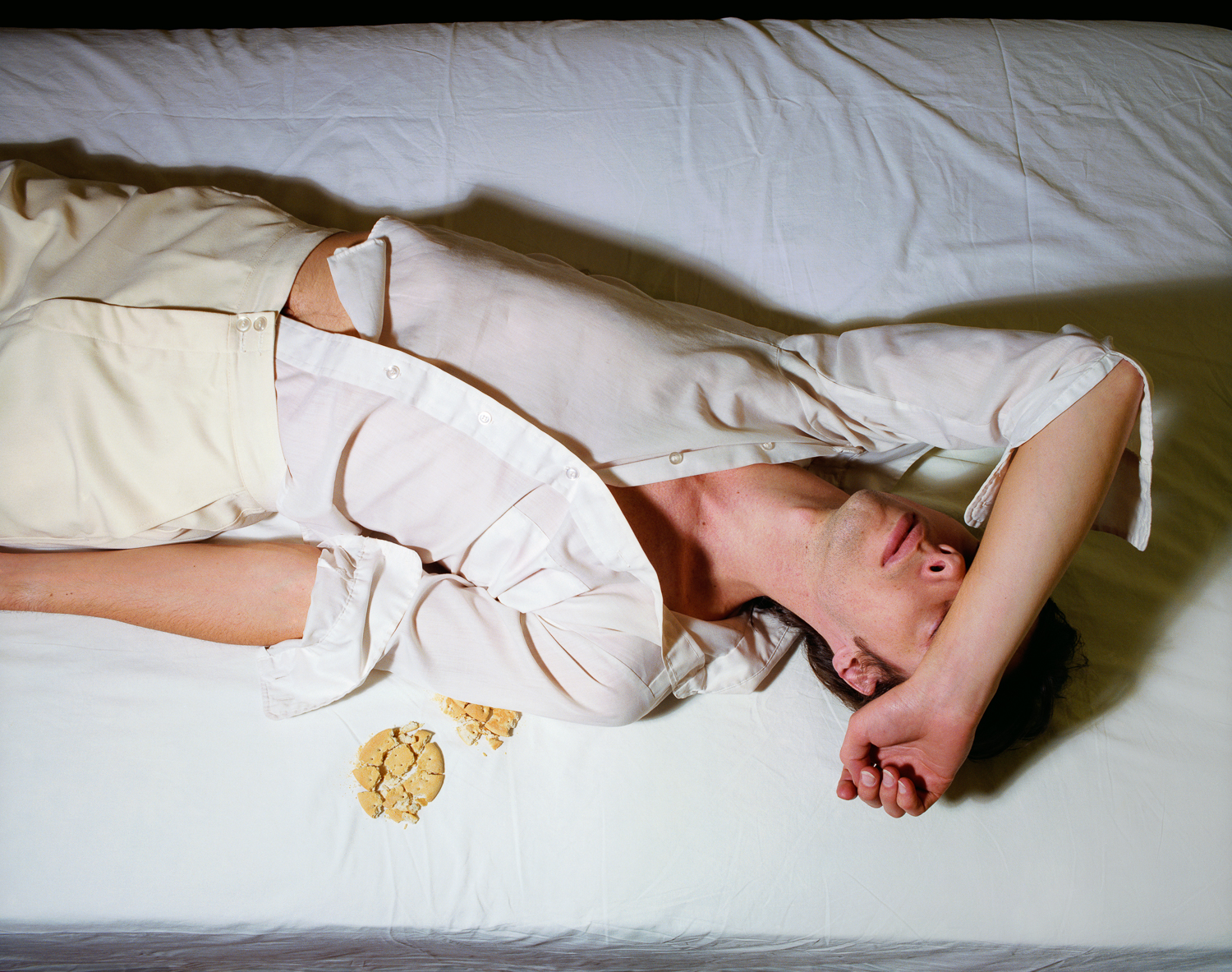 Now and Then © Jo Ann CallisMan on Bed with Crumbs, 1979, Archival Pigment Print, 16 x 20 inches