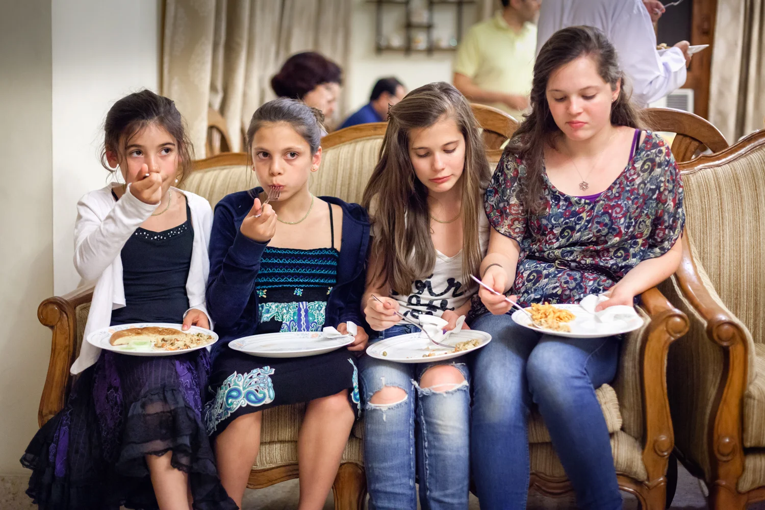 Party Girls : We were visiting family in India. It was our first time there, and my daughters and niece didn’t know anyone -- the people were different, the food was different. They squeezed together on the couch during the party and just watched what was going on.