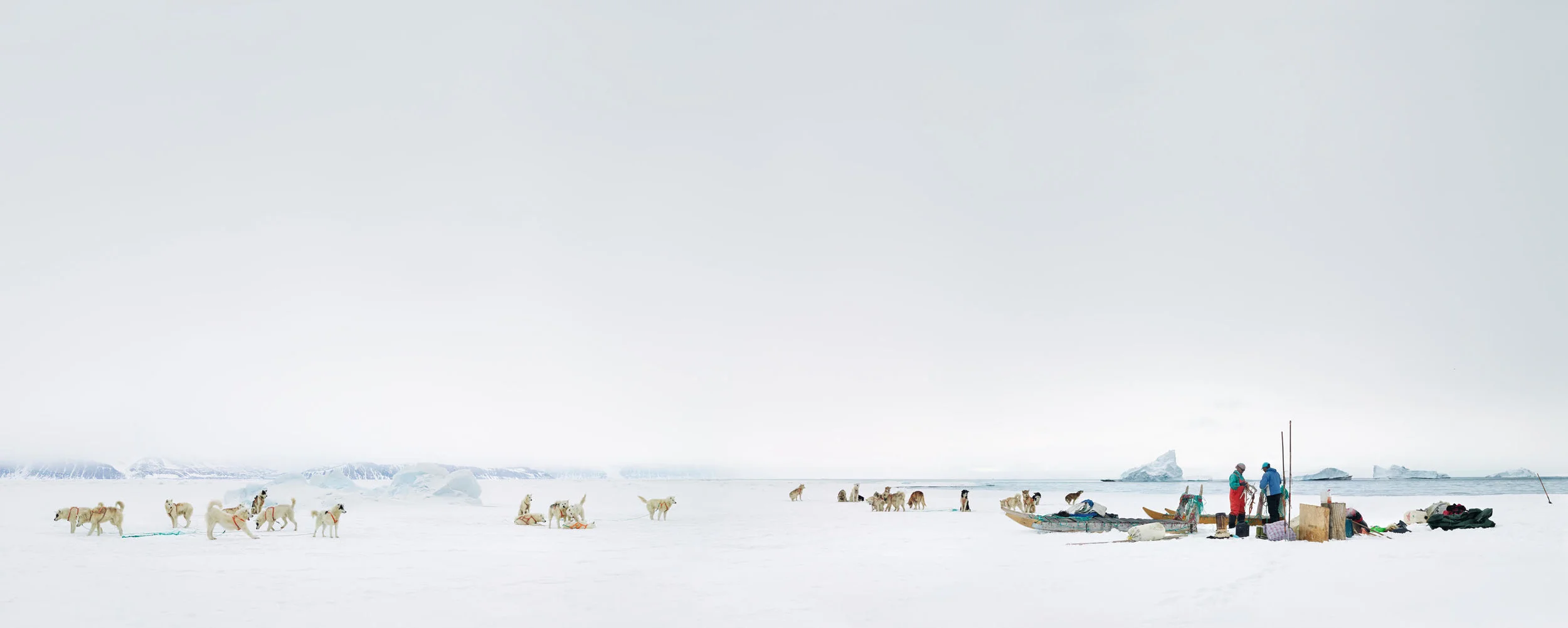 “Panorama After Hunt.” © Corina Gamma, Breaking Down the Sea Ice Camp, north east of Siorapaluk, Greenland 2018, 130 inches Panorama. Subsistence hunters Qillaq Danielsen and Peter Avike are taking down their sea ice camp after a hunting trip.